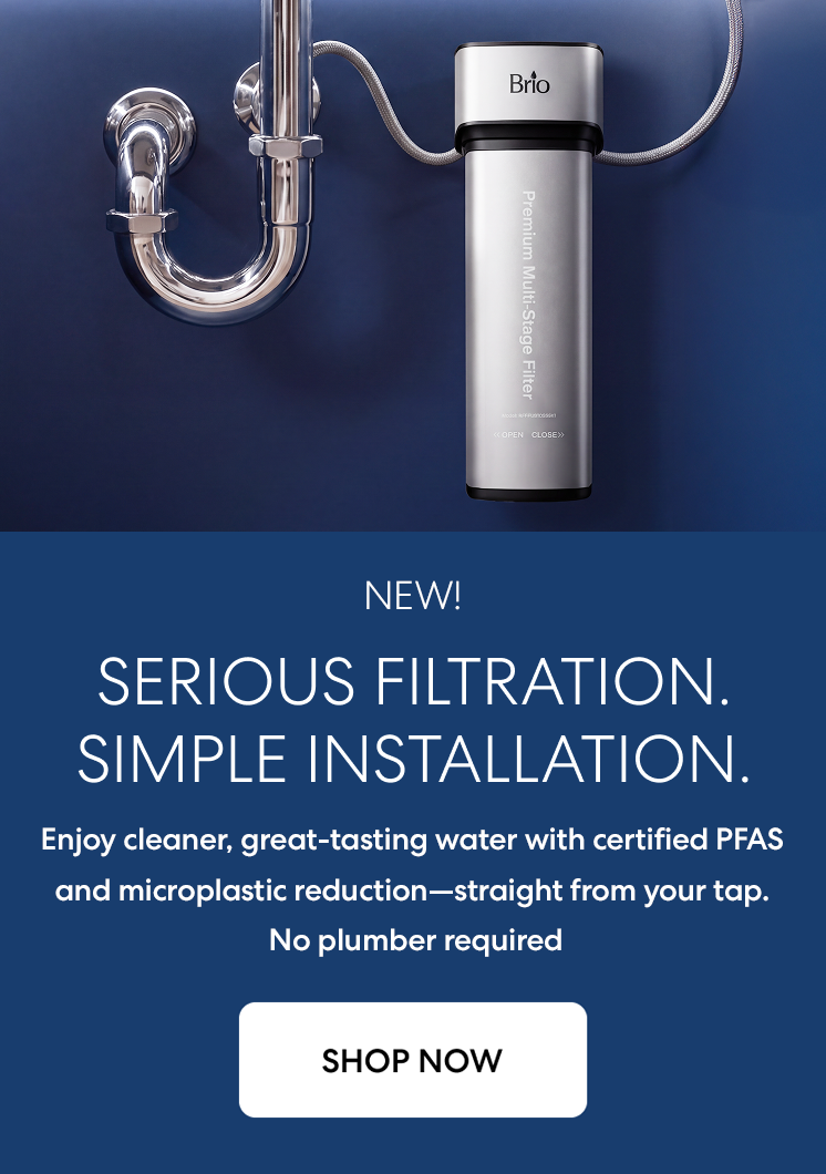 Brio premium undersink filtration system with PFAS removal shown installed to a sink on a dark blue background.