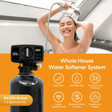 A smiling woman showers as the Brio Whole House Water Softener System (1-2 Bathrooms, 24,000 Grains) works above, highlighting softer skin, healthier hair, corrosion-free plumbing, longer appliance life, and brighter laundry.