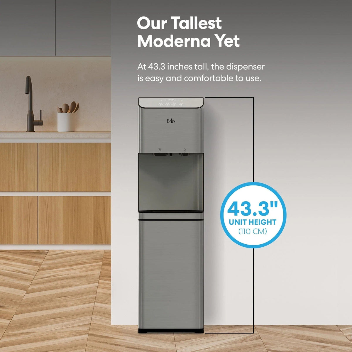 In a modern kitchen beside wooden cabinets, the Bottom Load Bullet Ice & Hot/Cold Water Stainless Steel Dispenser – Moderna 720 Ice stands tall at 43.3 inches (110 cm), making it the tallest model available. Its sleek silver design features a convenient bottom load water cooler and bullet ice maker, blending style with practicality for effortless hydration and easy use.