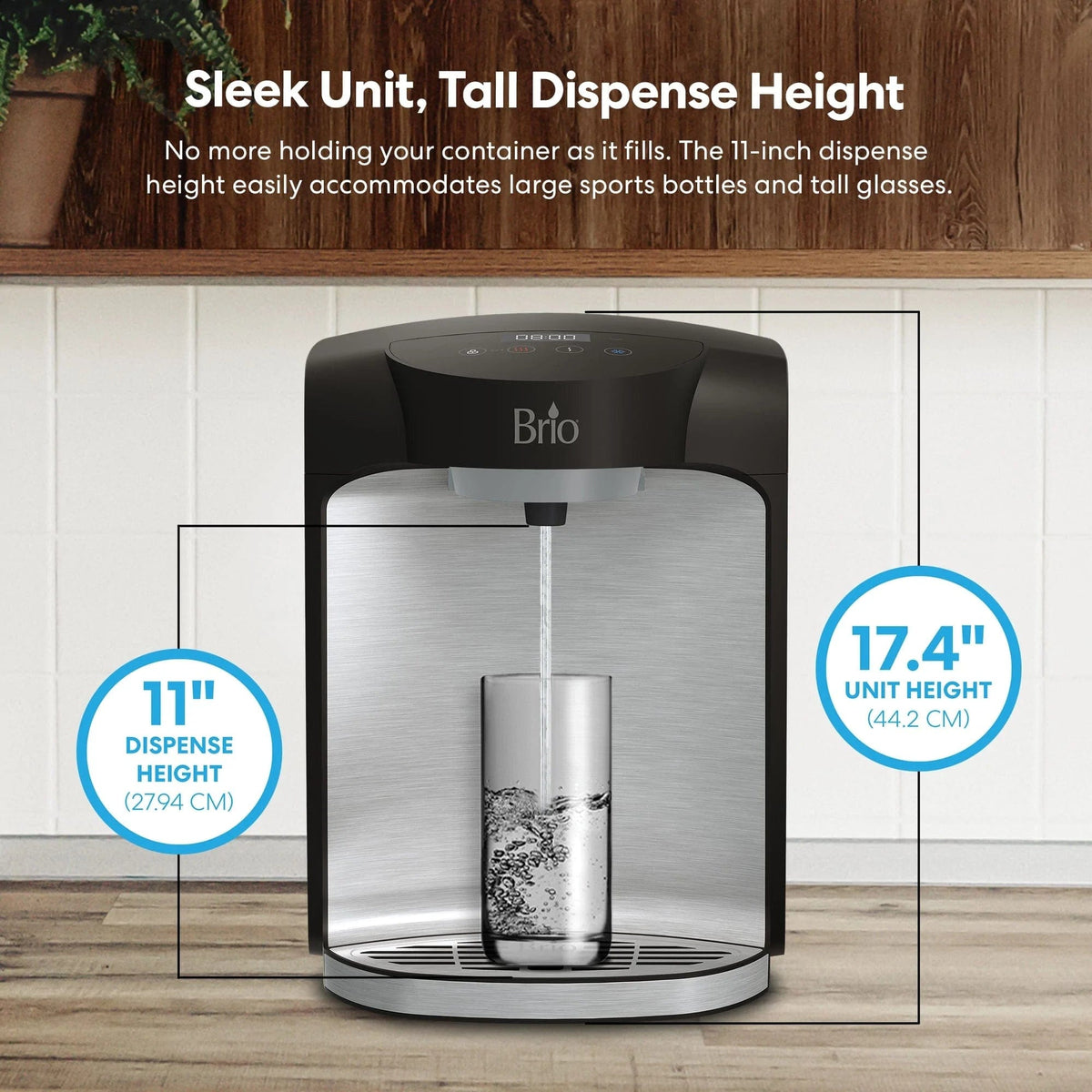The Stainless Steel Bottleless Countertop Water Dispenser - Model 820 easily fills a glass, showcasing its generous 11-inch dispense height and compact 17.4-inch unit height. The text points out its capacity to accommodate large bottles and tall glasses, along with rapid dispensing and efficient two-stage filtration. The dispenser sits on a wooden surface with plants in the background.