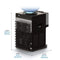 The Countertop Top Load Water Cooler - 520 Series, shown from the back, features a sleek black finish with external coils and a convenient control panel. It offers tri-temperature controls for versatile use and is constructed from durable stainless steel. Its dimensions are 20.5 inches (52 cm) in height, 12 inches (30.5 cm) in width, and 15.5 inches (39.4 cm) in length. A distinctive blue sphere rests on top of the unit.