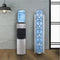 A water dispenser with a blue jug on top stands next to a Single Column 5-Bottle Storage Rack in white, which holds four large water jugs, all positioned against a gray wall with a black lamp hanging above.